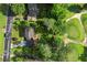 Birds eye view of a home with large trees next to a grassy golf course at 4379 Bonaparte Dr, Tucker, GA 30084