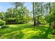 Large, well-maintained backyard with lush green grass and mature trees, perfect for outdoor activities at 4379 Bonaparte Dr, Tucker, GA 30084