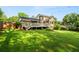 Exterior view of the home from backyard with a covered porch and nice landscaping at 4379 Bonaparte Dr, Tucker, GA 30084