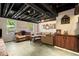 Finished basement with exposed ceiling, sofa and decorative wood paneling at 4379 Bonaparte Dr, Tucker, GA 30084