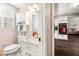 Bathroom featuring a vanity with storage, toilet, and view into a kitchen and living area at 4379 Bonaparte Dr, Tucker, GA 30084