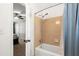 A bathroom with a blue shower curtain beside a door opening into a bedroom with neutral walls at 4379 Bonaparte Dr, Tucker, GA 30084