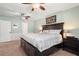 Bedroom featuring neutral carpet, a bed, ceiling fans, and bright natural light at 4379 Bonaparte Dr, Tucker, GA 30084