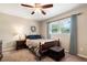 Bedroom with a ceiling fan, light beige walls, carpeted floors and sunny windows at 4379 Bonaparte Dr, Tucker, GA 30084
