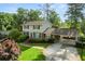 Charming two-story home with a brick facade, spacious driveway, well-manicured lawn, and inviting carport at 4379 Bonaparte Dr, Tucker, GA 30084
