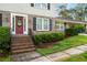 Inviting front entrance with a vibrant red door, brick steps, and manicured landscaping at 4379 Bonaparte Dr, Tucker, GA 30084