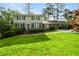 A charming two-story home features a well-manicured lawn, complemented by a convenient carport at 4379 Bonaparte Dr, Tucker, GA 30084