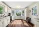 Eat-in kitchen area featuring natural light, bay windows, and hardwood flooring at 4379 Bonaparte Dr, Tucker, GA 30084