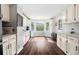 Bright kitchen with white cabinets, granite countertops, subway tile backsplash, and hardwood floors at 4379 Bonaparte Dr, Tucker, GA 30084