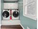 Convenient laundry room with modern washer and dryer units and ample storage space at 4379 Bonaparte Dr, Tucker, GA 30084