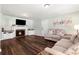 Bright living room with hardwood floors, fireplace, and neutral furniture at 4379 Bonaparte Dr, Tucker, GA 30084