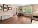 Living room featuring hardwood floors, a large window with blinds, and neutral decor at 4379 Bonaparte Dr, Tucker, GA 30084