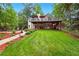 Expansive backyard featuring a well-maintained lawn, patio area, and lush greenery, perfect for outdoor living at 827 Pinehurst Dr, Woodstock, GA 30188
