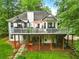 Expansive backyard featuring a large elevated deck, a stone pathway and lush, mature landscaping at 827 Pinehurst Dr, Woodstock, GA 30188
