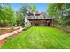 Spacious backyard featuring a large elevated deck, a stone pathway and lush, mature landscaping at 827 Pinehurst Dr, Woodstock, GA 30188