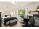 Functional bedroom featuring a dark-color palette, a designated workspace, and natural light at 827 Pinehurst Dr, Woodstock, GA 30188