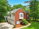 Charming brick and siding home with a well-kept lawn and a driveway leading to the garage at 827 Pinehurst Dr, Woodstock, GA 30188