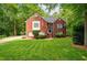 Classic brick home with manicured lawn and mature landscaping at 827 Pinehurst Dr, Woodstock, GA 30188