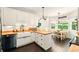 Well-lit kitchen featuring white cabinets, butcher block countertops, a farmhouse sink, and stainless steel appliances at 827 Pinehurst Dr, Woodstock, GA 30188