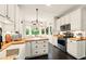 Well-lit kitchen featuring stainless steel appliances, butcher block countertops, white cabinets, and a breakfast nook at 827 Pinehurst Dr, Woodstock, GA 30188