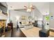 Cozy living room featuring a stone fireplace, vaulted ceilings, neutral colors, and modern furniture at 827 Pinehurst Dr, Woodstock, GA 30188