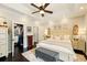 Inviting main bedroom boasts a tray ceiling, ceiling fan, and closet with ample storage at 827 Pinehurst Dr, Woodstock, GA 30188