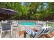 Backyard in-ground pool with surrounding deck, featuring lounge chairs and umbrella, perfect for summer relaxation at 827 Pinehurst Dr, Woodstock, GA 30188