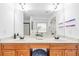 Bathroom with double vanity, wood cabinets and large mirror at 891 Channel Dr, Lawrenceville, GA 30046