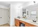 Bathroom featuring double sinks, vanity area, and an adjacent soaking tub at 891 Channel Dr, Lawrenceville, GA 30046