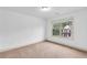 Well-lit bedroom with neutral carpet and large window offering natural light at 891 Channel Dr, Lawrenceville, GA 30046