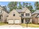 Charming two-story home with a two-car garage and manicured front lawn at 891 Channel Dr, Lawrenceville, GA 30046