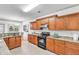 A well-equipped kitchen with granite countertops and wood cabinets at 891 Channel Dr, Lawrenceville, GA 30046
