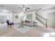Open living area with staircase, comfortable seating, and neutral color palette at 891 Channel Dr, Lawrenceville, GA 30046