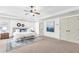 Spacious bedroom with tray ceiling, ceiling fan, and neutral color palette at 891 Channel Dr, Lawrenceville, GA 30046
