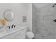 Stylish bathroom with marble-tiled shower, sleek fixtures, vanity and round mirror creating a spa-like feel at 101 Fairfield Ct, Atlanta, GA 30314