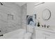 Bathroom with marble-look tiled shower, sleek fixtures, vanity and framed mirror creating a spa-like feel at 101 Fairfield Ct, Atlanta, GA 30314