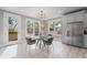 Bright breakfast nook with a glass table, modern chairs, and views of the backyard at 101 Fairfield Ct, Atlanta, GA 30314