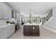 Bright, spacious kitchen featuring an island with bar seating, modern lighting, and stainless appliances at 101 Fairfield Ct, Atlanta, GA 30314