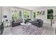 Bright living room with large windows showcasing the serene outdoor view and stylish interior decor at 101 Fairfield Ct, Atlanta, GA 30314