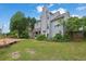 Exterior of the home showcasing a spacious deck, lush backyard, and attractive landscaping at 1663 Willow Way, Woodstock, GA 30188