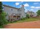 Exterior view of a home with a deck, stairs, and a well-maintained lawn and landscape at 1663 Willow Way, Woodstock, GA 30188