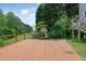 Backyard deck featuring a built-in fireplace, ideal for cozy outdoor entertaining at 1663 Willow Way, Woodstock, GA 30188