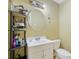 Well lit bathroom features a modern white vanity with storage and a circular mirror at 1663 Willow Way, Woodstock, GA 30188