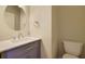 Bathroom featuring modern fixtures, including a sleek sink and a round mirror with vanity at 1663 Willow Way, Woodstock, GA 30188