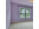 Bedroom with carpet, large window with blinds and soft purple walls at 1663 Willow Way, Woodstock, GA 30188