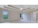 Large bedroom with tray ceiling, ceiling fan, and natural light from large windows at 1663 Willow Way, Woodstock, GA 30188