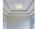 Bedroom featuring a tray ceiling with a ceiling fan and a large window for natural light at 1663 Willow Way, Woodstock, GA 30188