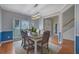 Elegant dining room with a modern light fixture, hardwood floors, and wainscoting at 1663 Willow Way, Woodstock, GA 30188