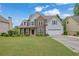 Charming two-story home with brick accents and a well-manicured lawn at 1663 Willow Way, Woodstock, GA 30188