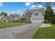 Inviting home with a spacious driveway and a beautifully landscaped front yard at 1663 Willow Way, Woodstock, GA 30188